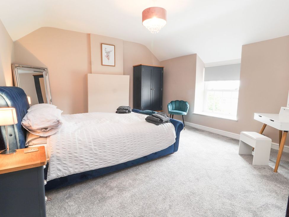 A bedroom with a bed and desk at Cae Adar Farm Wrexham