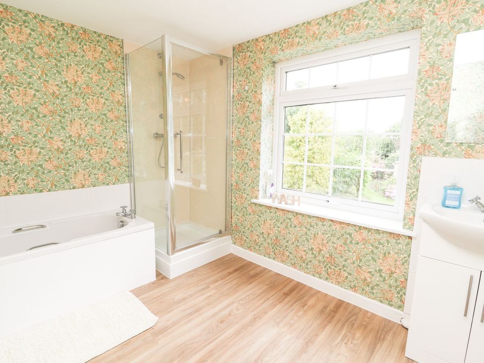 A bathroom with a bathtub and shower at Cae Adar Farm in Wrexham