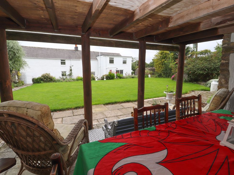 An outdoor seating area with a view of a garden at Cae Adar Farm Wrexham