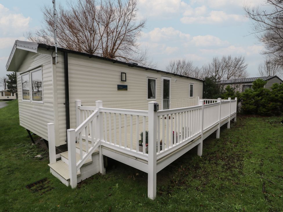 A mobile home with a deck and railing at Willerby Ellerrton (delyn)
