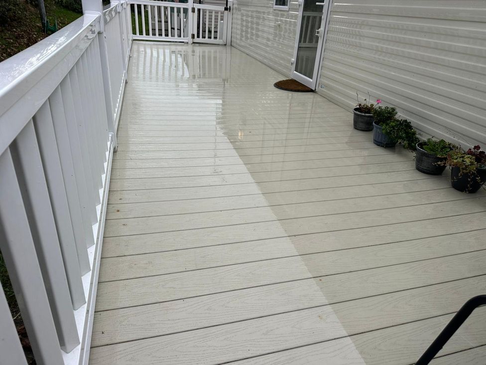 A deck area with plants and a door at Willerby Ellerrton (delyn) Prestatyn