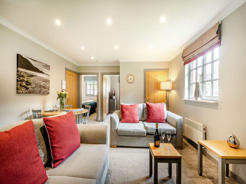 A living room with a sofa and a small table at Arran Lodge Spa in Dailly