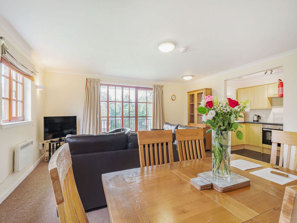 A living room with a dining table and sofa at Turnberry in Dailly