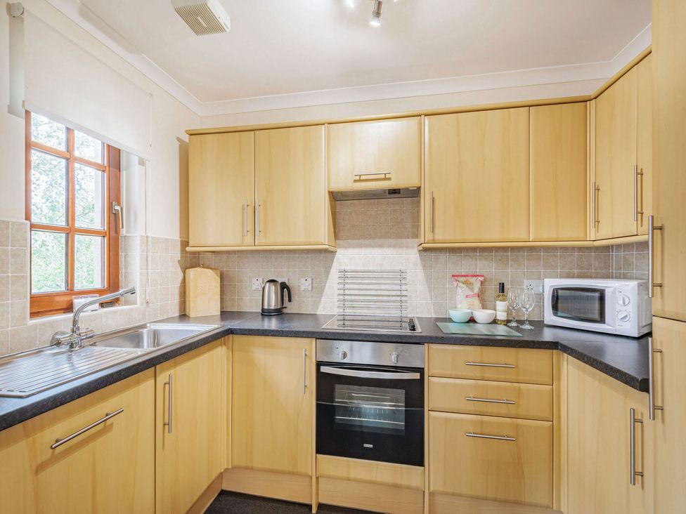A kitchen with cabinets and appliances at Turnberry in Dailly
