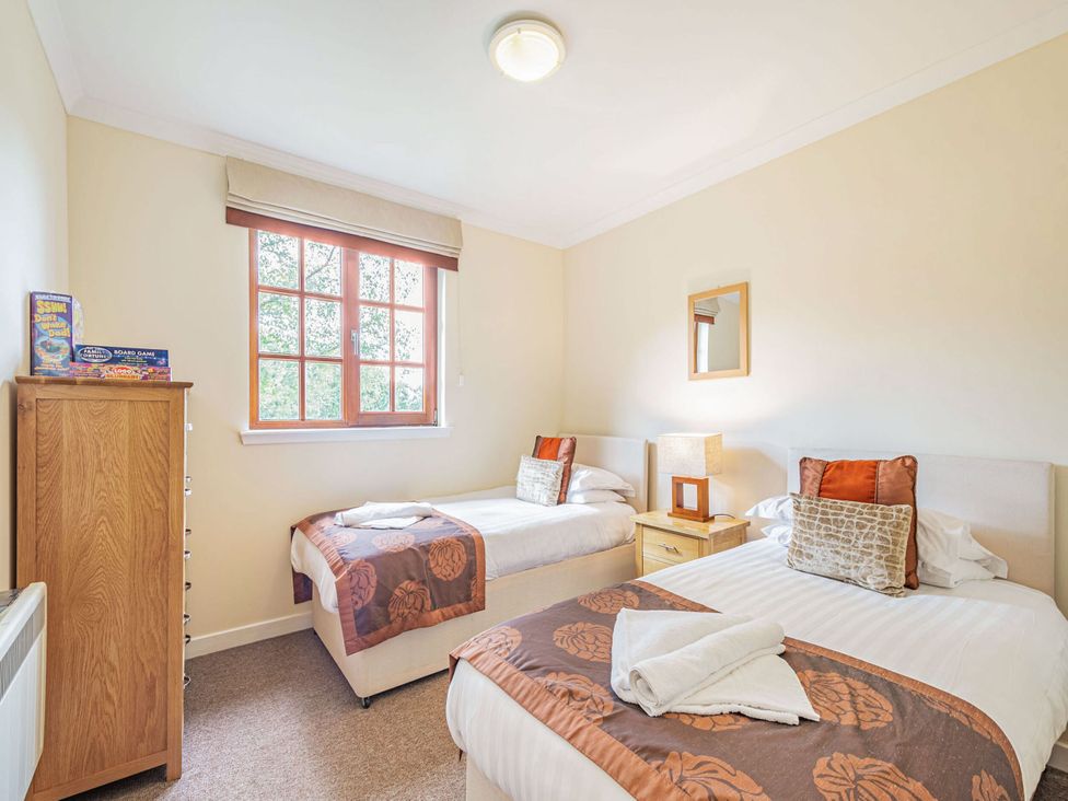 A bedroom with two beds and a window at Turnberry in Dailly