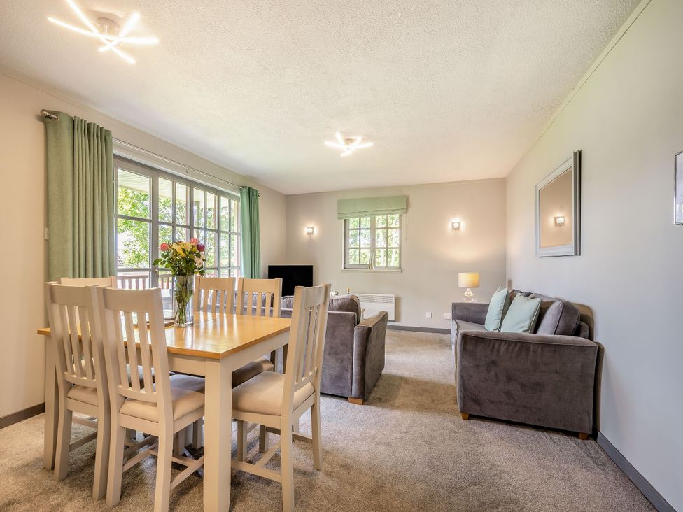 A living room with a dining table and sofa at Brunston in Dailly