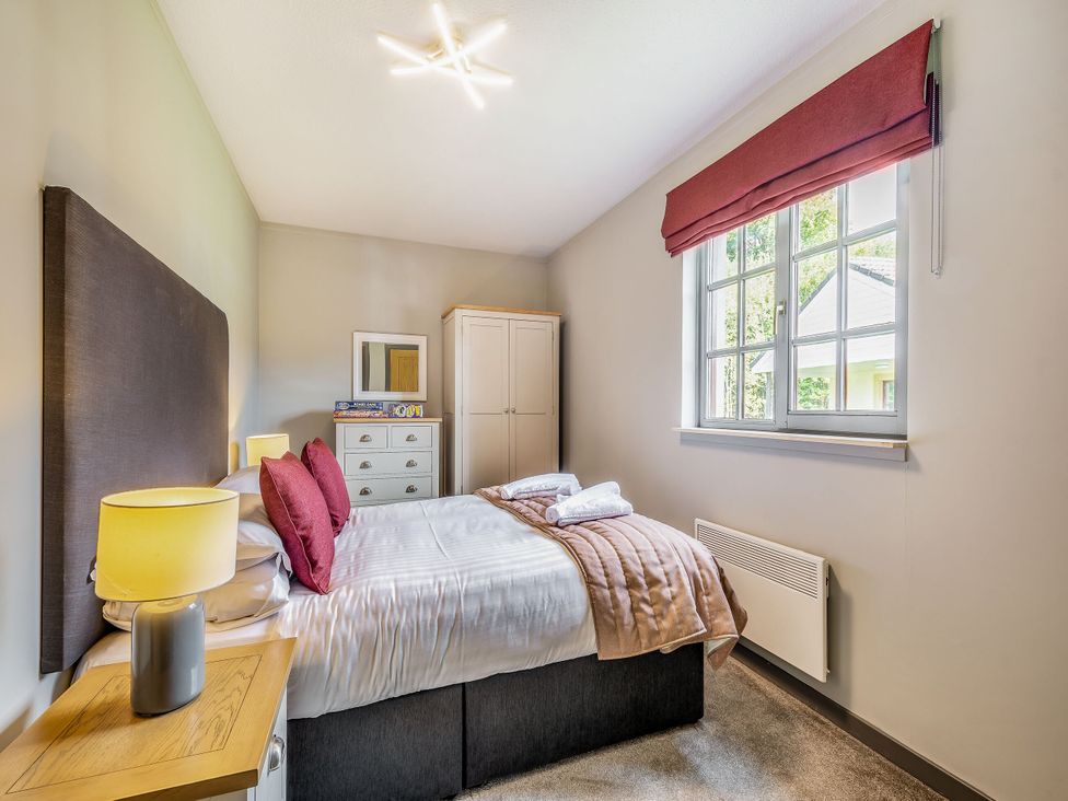 A bedroom with a bed and wardrobe at Brunston in Dailly