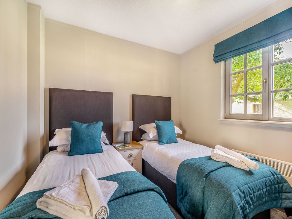 A bedroom with two beds and a window at Brunston in Dailly