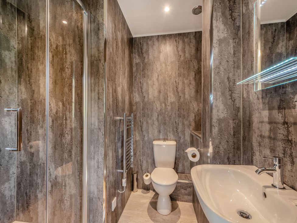 A bathroom with a shower, toilet and sink at Brunston in Dailly