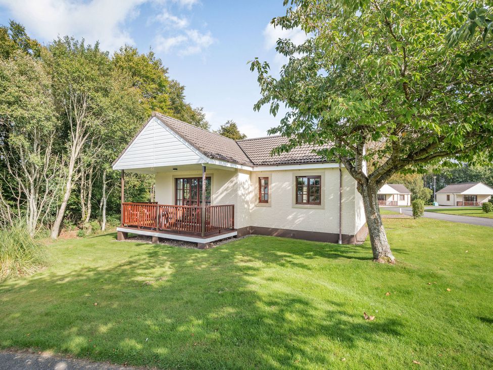 A house with a porch and trees at Brunston (Pet) in Dailly