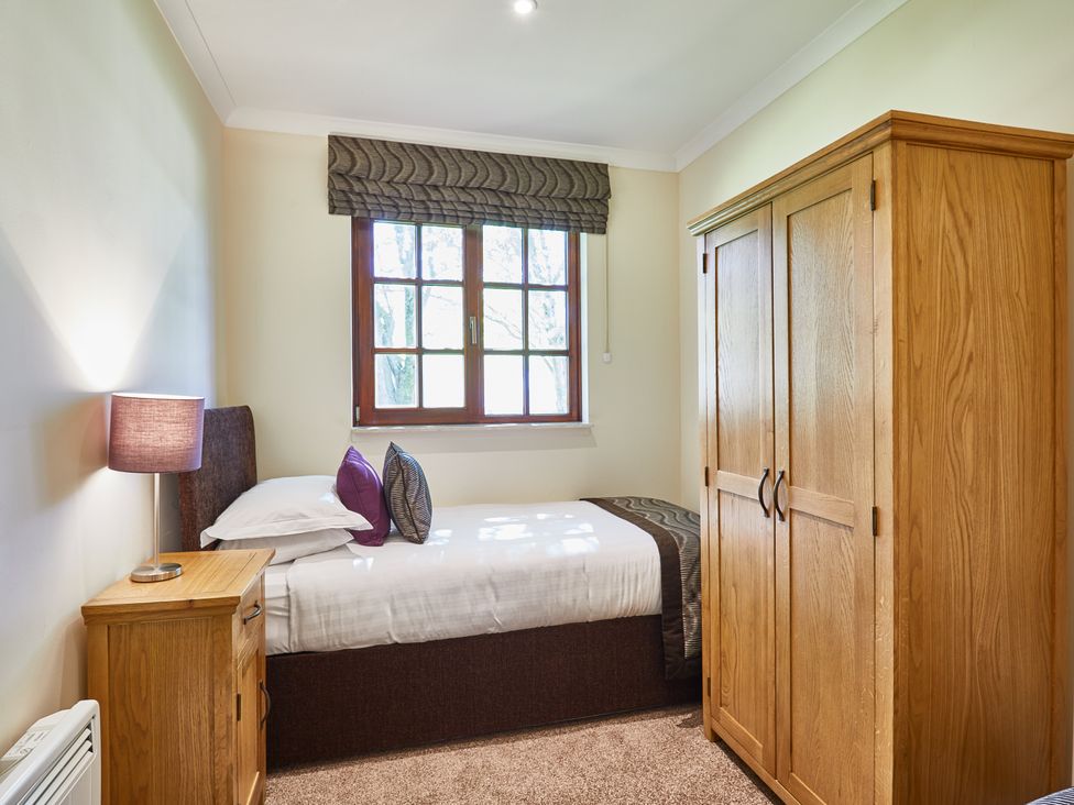 A bedroom with a bed and wardrobe at Brunston (Pet) in Dailly
