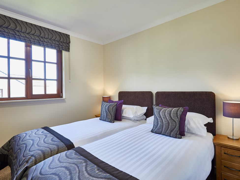 A bedroom with twin beds and a window at Brunston (Pet) Dailly