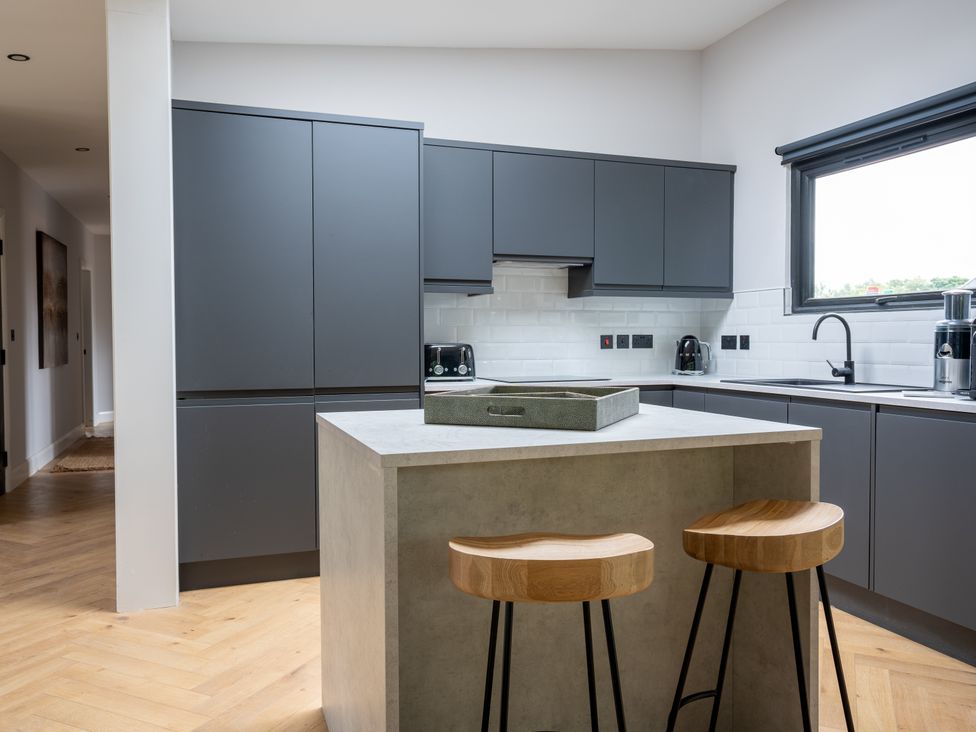 A kitchen with gray cabinets and a countertop at Cabin 2.0 in Dumfries