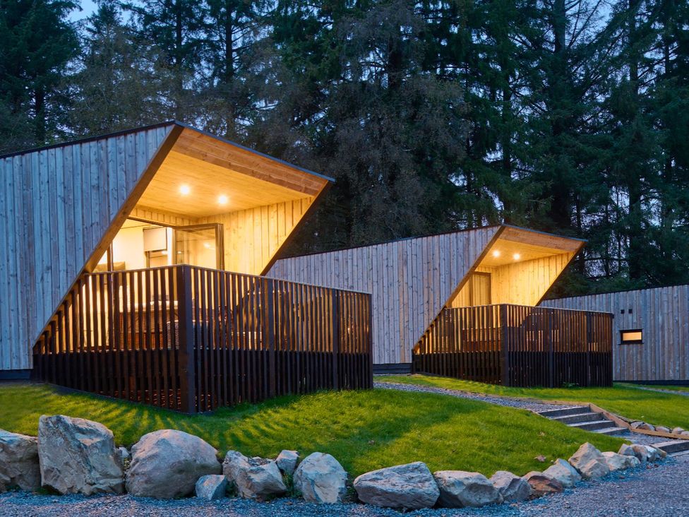 Two modern cabins with wooden exteriors and balconies at Orka 2.0 Kinder (Pet) Dumfries