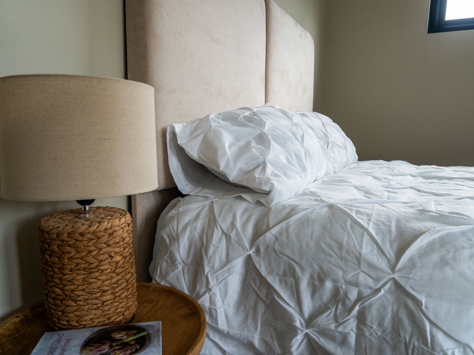 A bedroom with a bed and lamp at Cabin 3.0 Deluxe in Dumfries