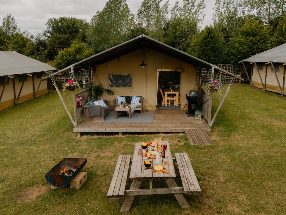 An outdoor area with a tent and seating at Standard Safari Tent in Fair Oak