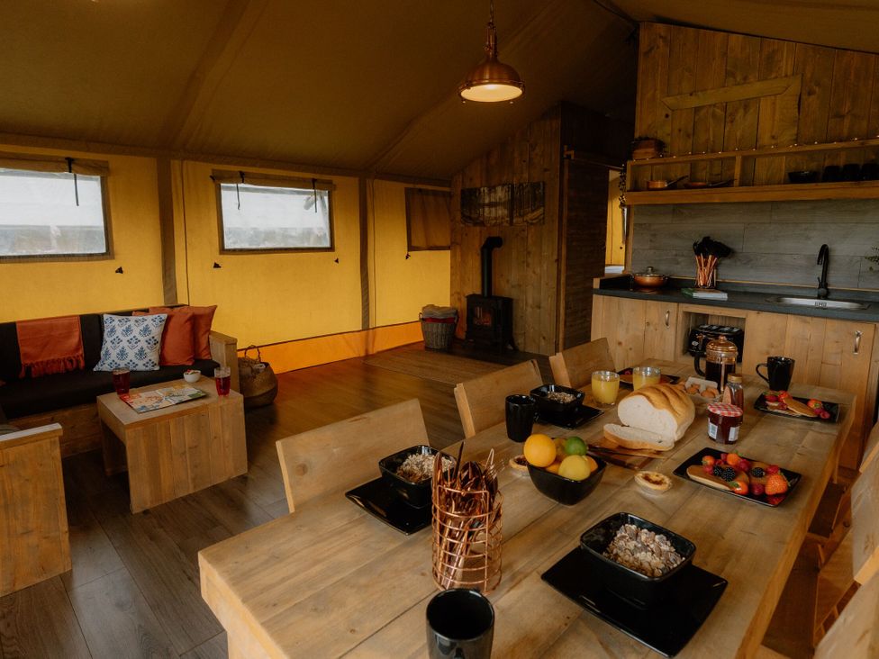 A dining area with a table and kitchen counter at Standard Safari Tent in Fair Oak
