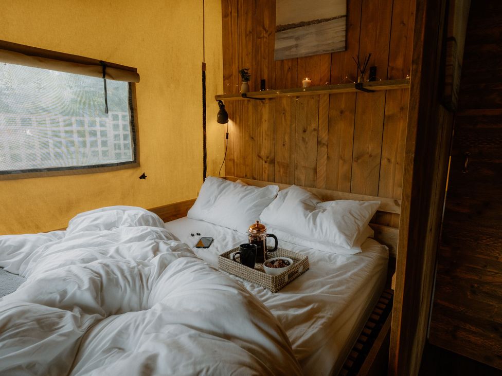 A bedroom with a bed and a coffee tray at Standard Safari Tent in Fair Oak