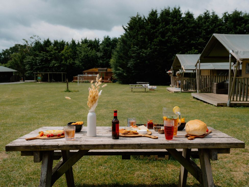 A table with food and drinks at Standard Safari Tent in Fair Oak