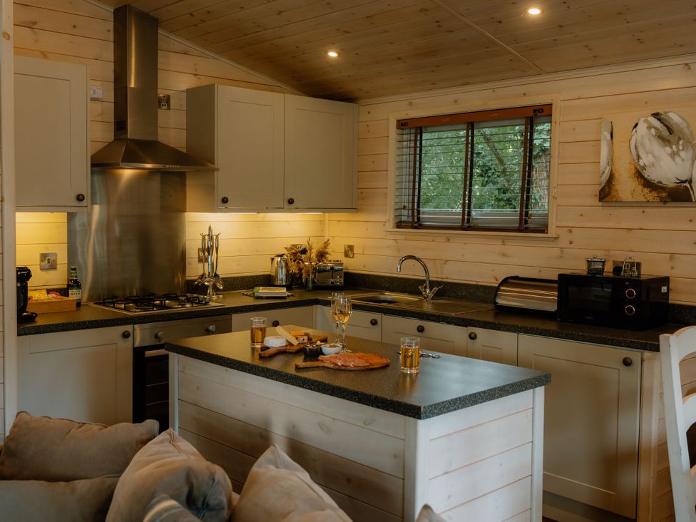 A kitchen with a sink and stove at Spitfire Lodge in Fair Oak