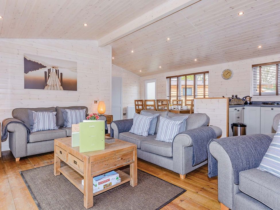 A living room with sofas and a coffee table at Lancaster Lodge in Fair Oak