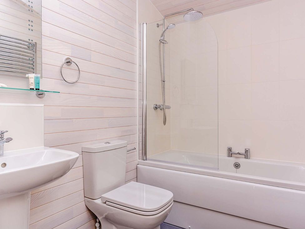A bathroom with a bathtub and shower at Lancaster Lodge in Fair Oak
