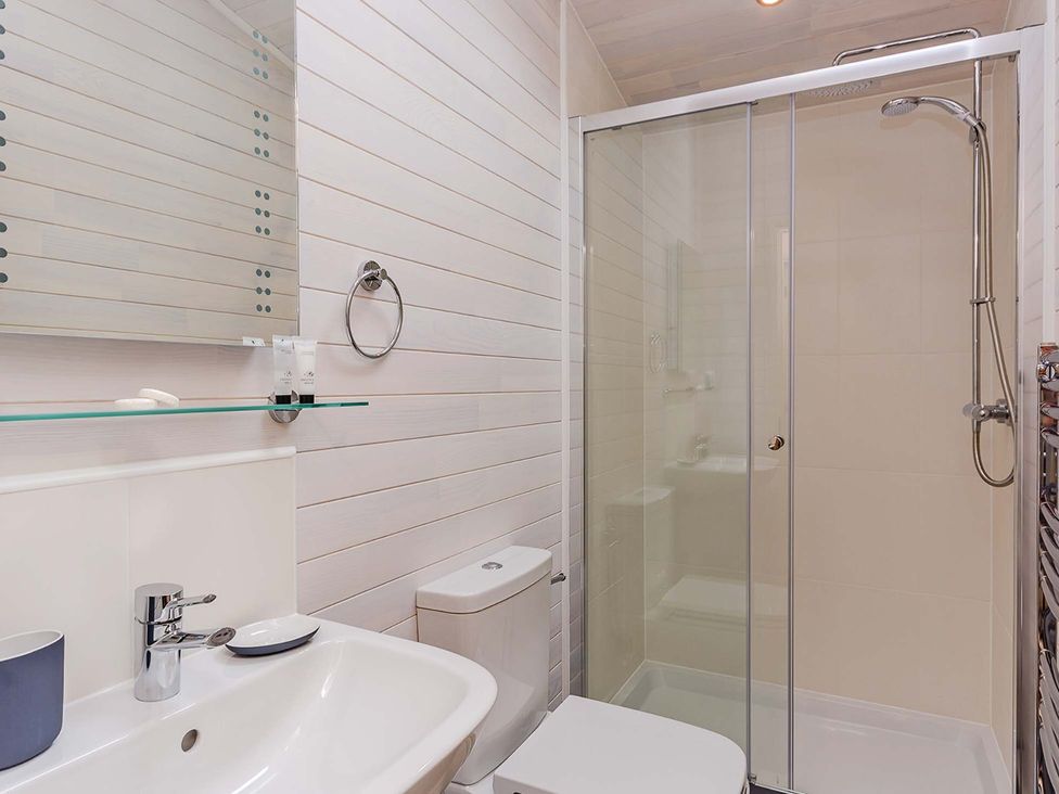 A bathroom with shower and sink at Lancaster Lodge in Fair Oak