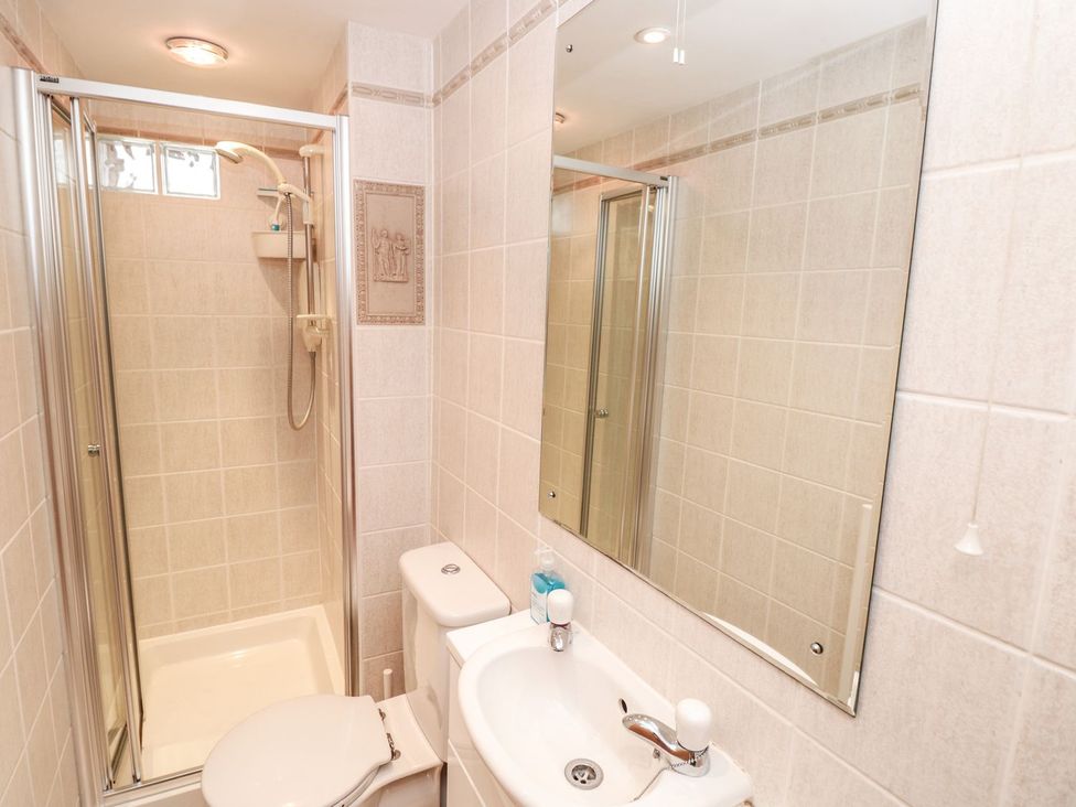 A bathroom with shower, toilet, and sink at The Little Clock House in Dartmouth