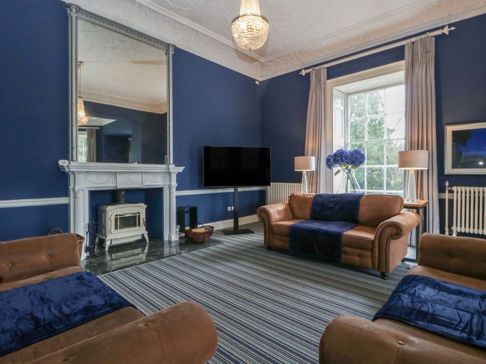 A living room with a sofa and television at Frenchay Park House in Bristol