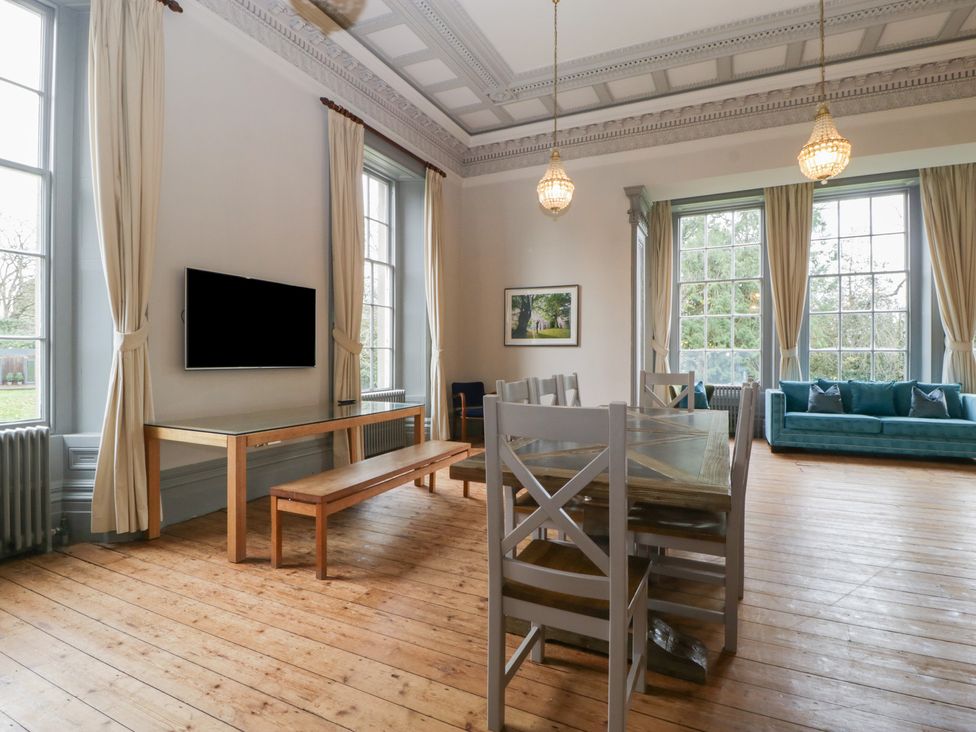 A dining room with a table and chairs at Frenchay Park House in Bristol