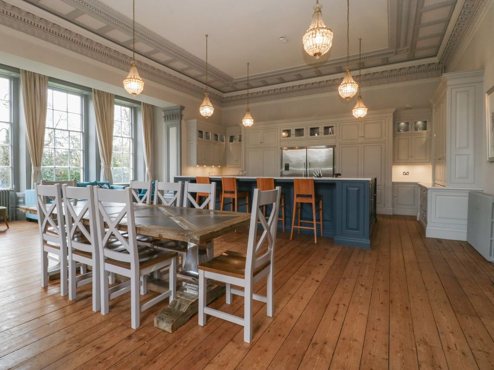 A kitchen with tables and chairs at Frenchay Park House in Bristol