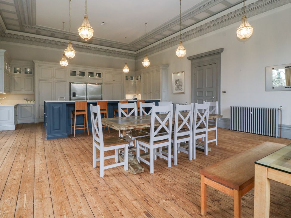 A kitchen with an island and dining table at Frenchay Park House Bristol