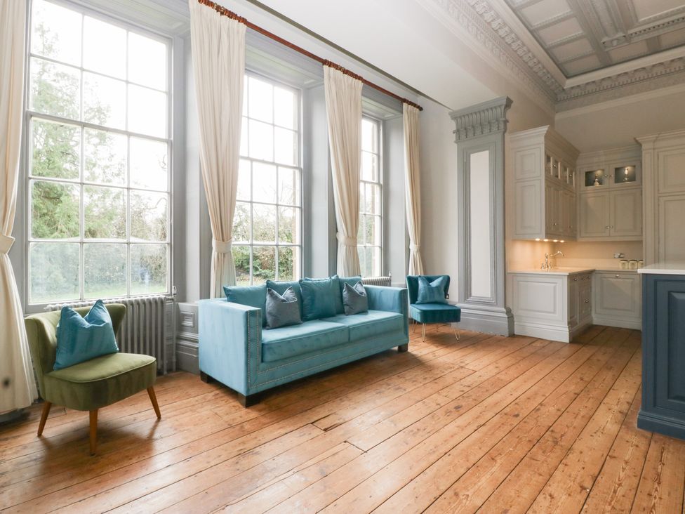 A living room with a sofa and chairs at Frenchay Park House in Bristol