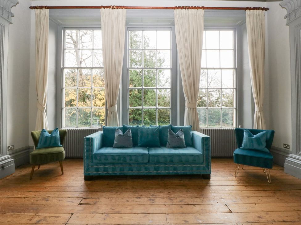 A living room with a sofa and armchair at Frenchay Park House in Bristol