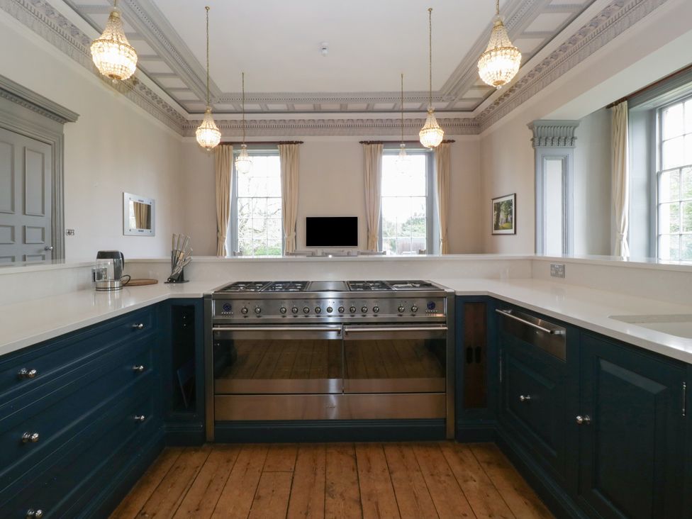 A kitchen with a stove and windows at Frenchay Park House in Bristol