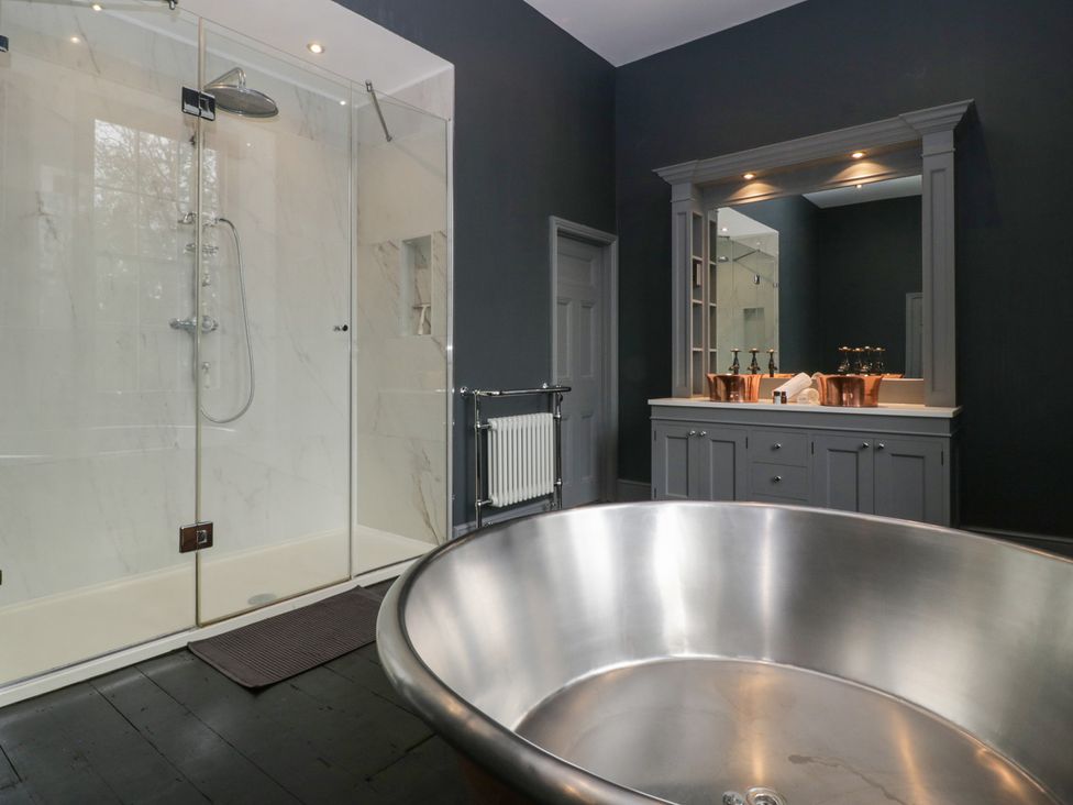 A bathroom with a shower, bathtub and sink at Frenchay Park House in Bristol