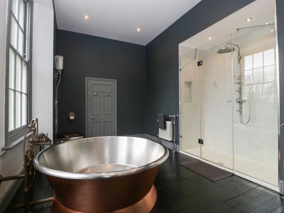 A bathroom with a bathtub and shower at Frenchay Park House in Bristol
