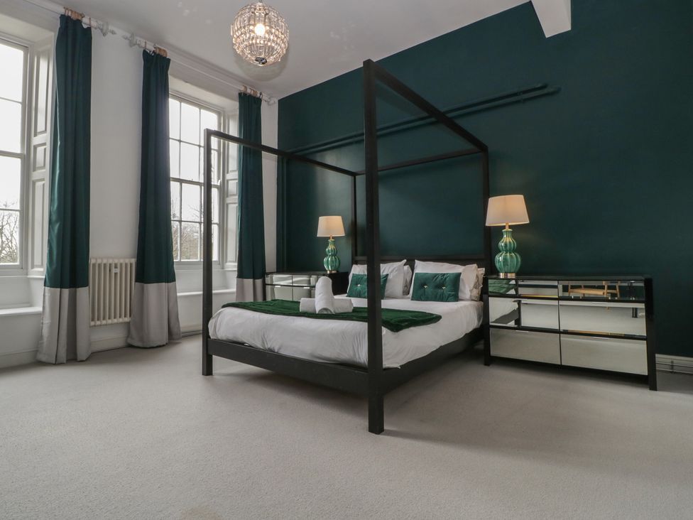 A bedroom with a bed and bedside lamps at Frenchay Park House in Bristol