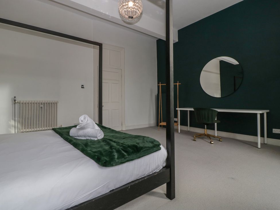 A bedroom with a bed and desk at Frenchay Park House in Bristol