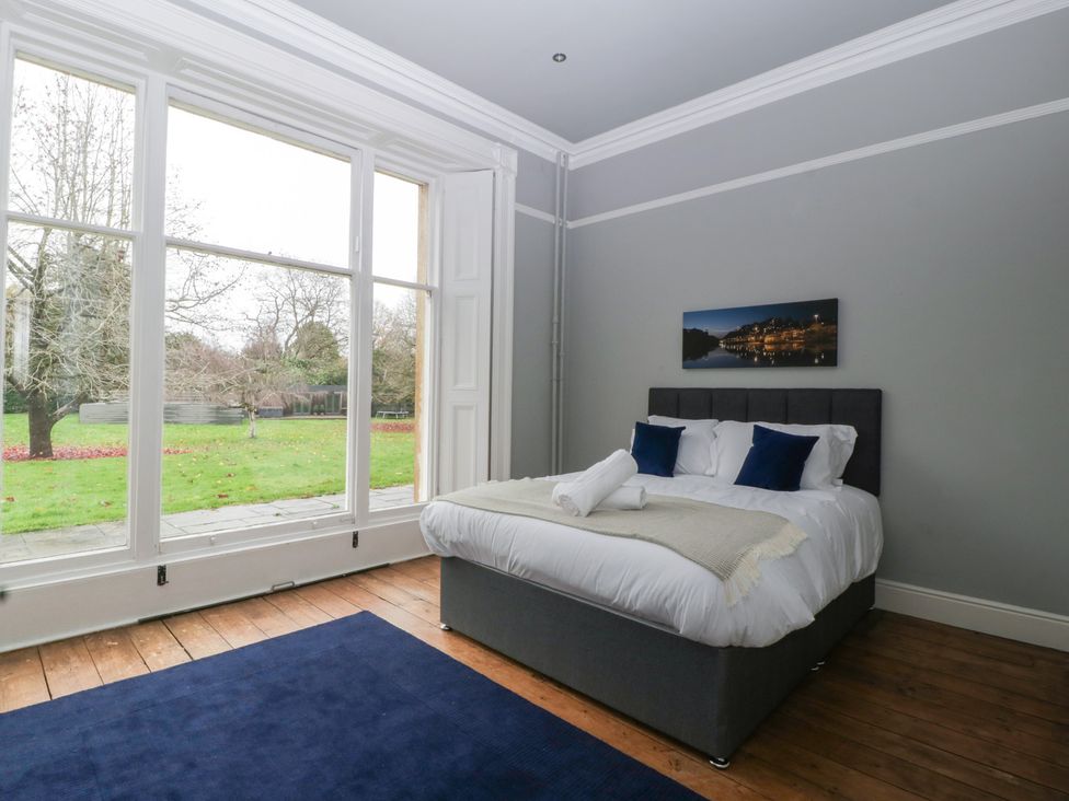 A bedroom with a bed and window at Frenchay Park House in Bristol