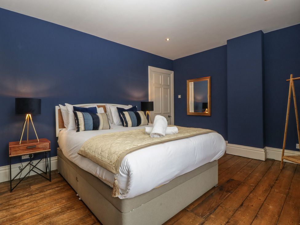 A bedroom with a bed and bedside lamps at Frenchay Park House in Bristol