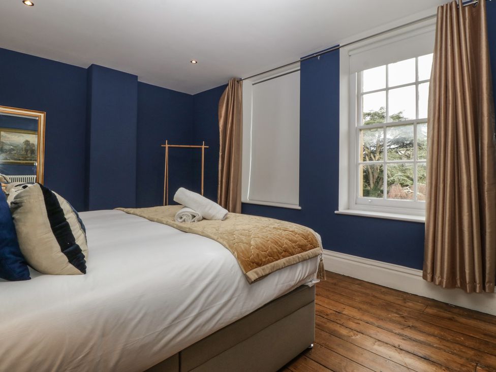 A bedroom with a bed and window at Frenchay Park House in Bristol