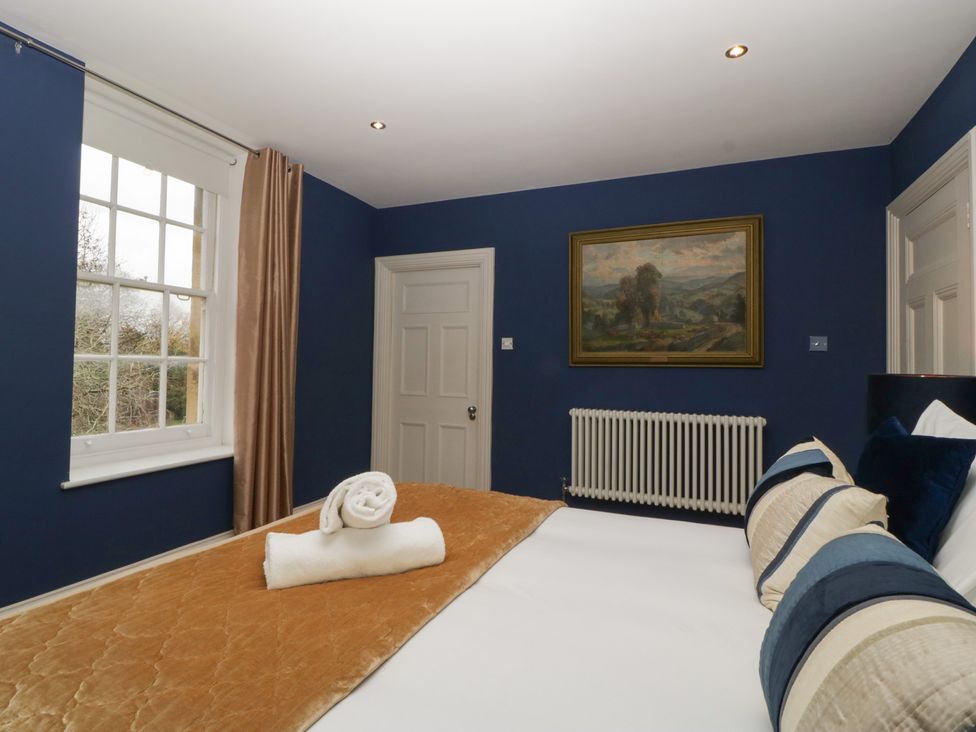 A bedroom with a bed and window at Frenchay Park House in Bristol