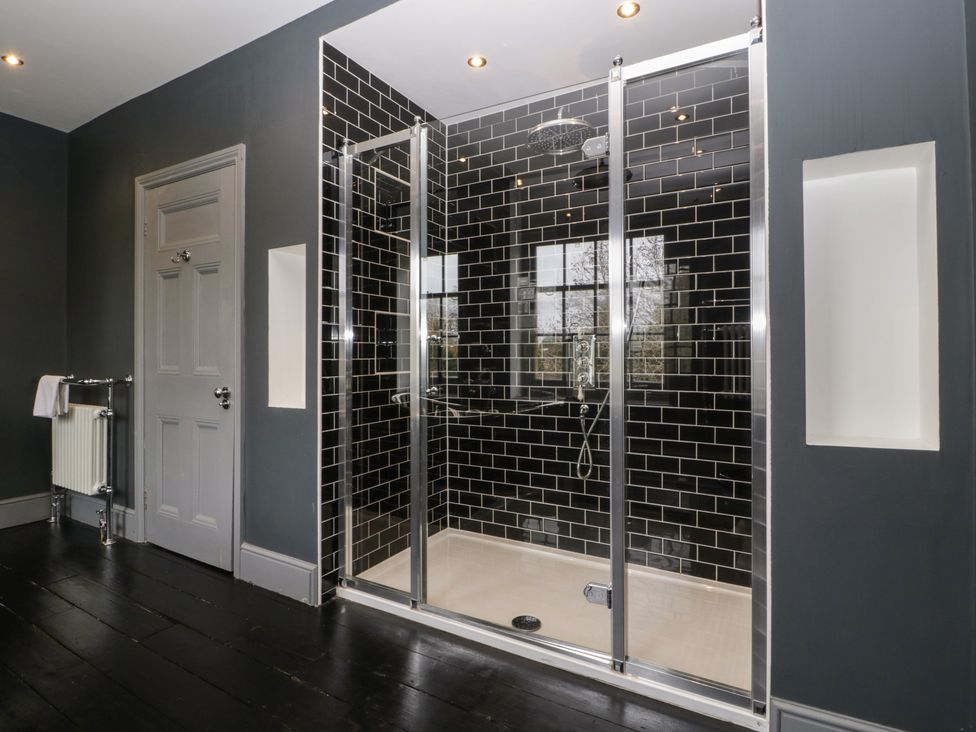 A bathroom with a shower and radiator at Frenchay Park House in Bristol