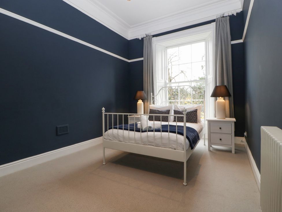 A bedroom with a bed and nightstand at Frenchay Park House in Bristol