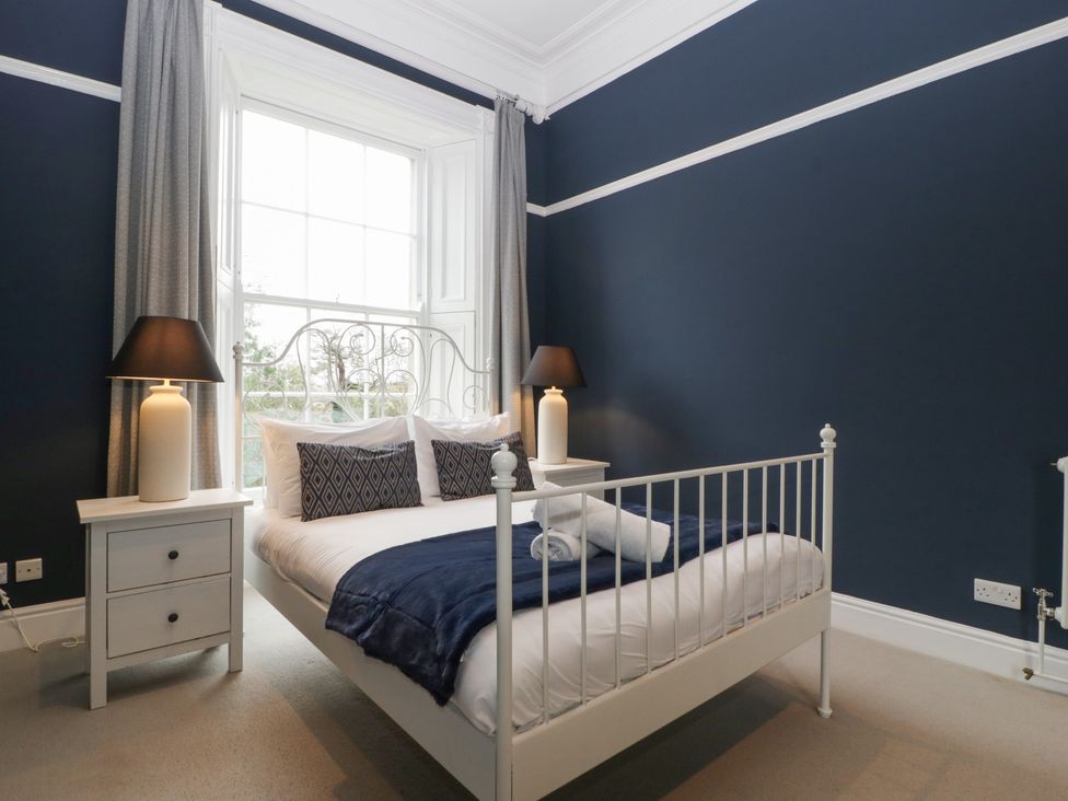 A bedroom with a bed and nightstand at Frenchay Park House, Bristol