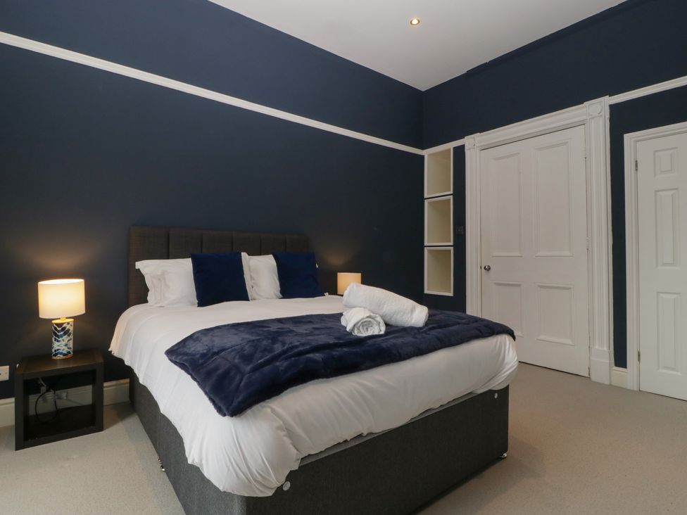 A bedroom with a bed and nightstand at Frenchay Park House in Bristol