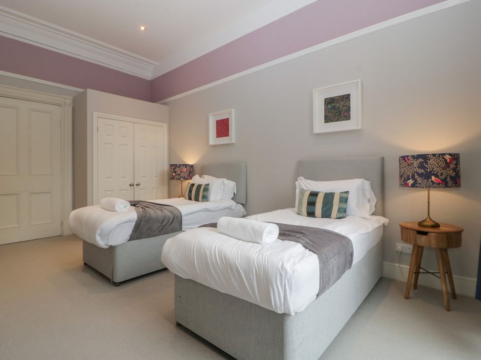 A bedroom with twin beds and wardrobe at Frenchay Park House in Bristol