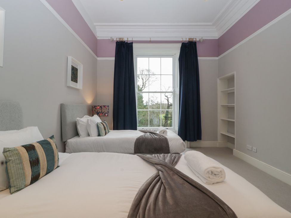 A bedroom with two beds and a window at Frenchay Park House in Bristol