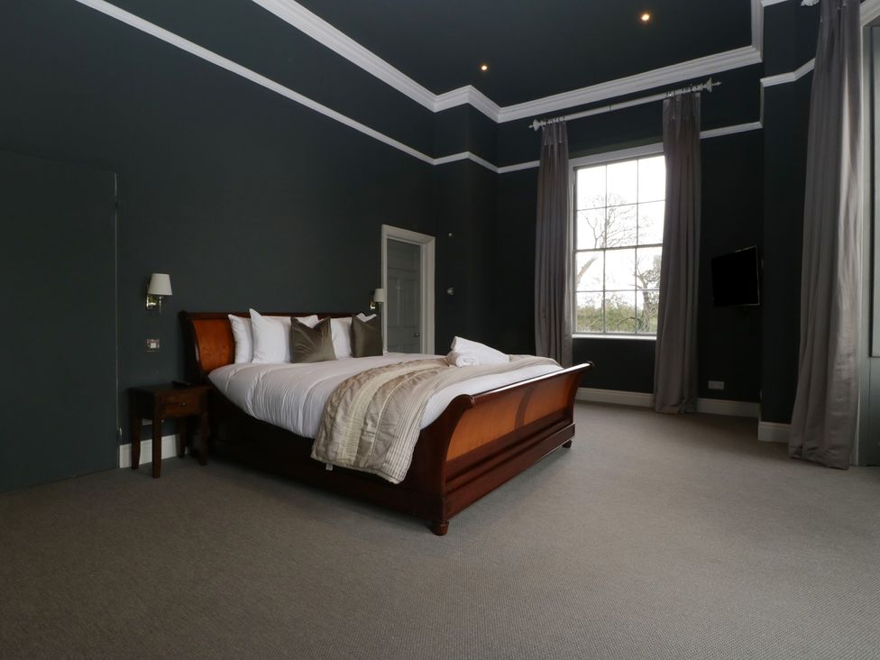 A bedroom with a bed and window at Frenchay Park House in Bristol